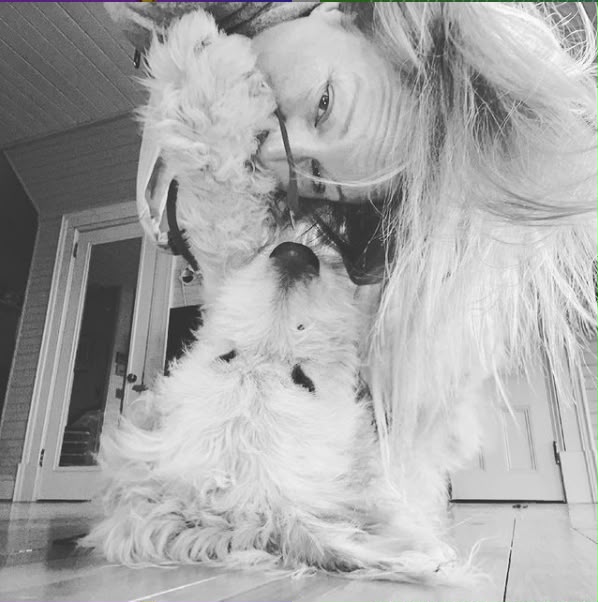Jennifer, founder of Studio Fascia, sharing a cuddle with her dog