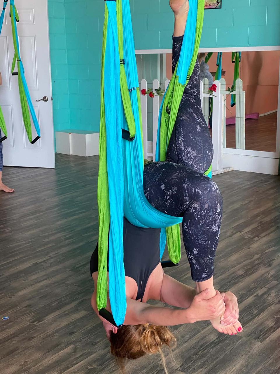An HSY™ aerial yoga inversion in a Studio Fascia suspension rig